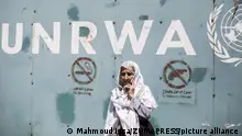July 31, 2018 - Gaza, Gaza Strip, Palestine - An elderly female protester seen standing outside the gate of the UNRWA office in Gaza..Hundreds of employees of the UN Relief and Works Agency for Palestine Refugees in the Near East (UNRWA) and their family members protest against job cuts announced by the agency outside its offices in Gaza City