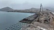 Cranes work in the construction of the Chancay Multipurpose Port Terminal, built by a Chinese company in Chancay, Peru, Tuesday, Aug. 22, 2023. (AP Photo/Cesar Barreto)