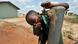 A boy drinks water from a tap in eastern Sierra Leone A boy drinks water from a tap in eastern Sierra Leone