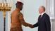 Handshake between Ibrahim Traore, wearing miltary attire, and Vladimir Putin, wearing a black suit