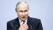 Russian President Vladimir Putin gestures with his hand as he speaks from behind two microphones Russian President Vladimir Putin gestures with his hand as he speaks from behind two microphones