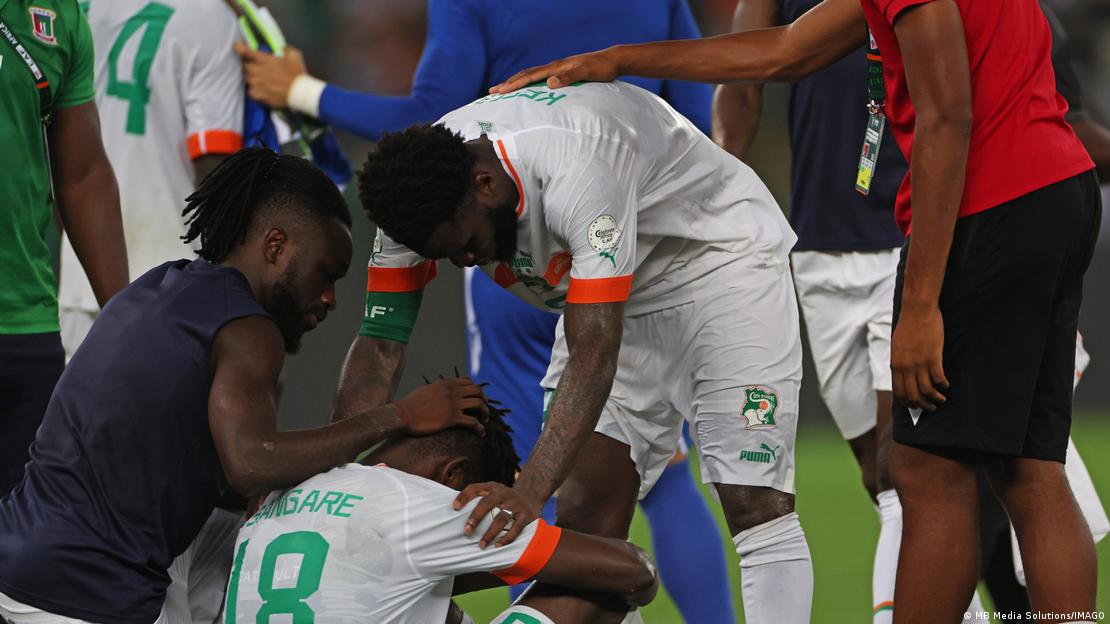 Ivory Coast players are disappointed on the ground after their loss to Equatorial-Guinea