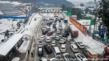 06/02/24***In this photo released by Xinhua News Agency, vehicles wait in line at the entrance to an expressway covered with snow in central China's Hunan Province on Tuesday, Feb. 6, 2024. Highway and railway traffic are gradually restored after an icy conditions trapped thousands of motorists on highways in central China as snow and freezing rain snarled travel by air, train and road during the annual Lunar New Year holiday rush. (Chen Sihan/Xinhua via AP)