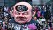 A carnival float shows a giant smiling effigy of German Chancellor Olaf Scholz's head with a large hole in his head. A carnival float shows a giant smiling effigy of German Chancellor Olaf Scholz's head with a large hole in his head.