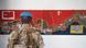 A soldier standing before a map of the buffer zone