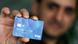 An asylum seeker with a payment card in his hand An asylum seeker with a payment card in his hand
