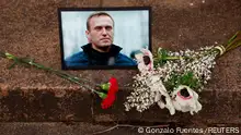 Flowers and a portrait of Russian opposition leader Alexei Navalny are seen following Navalny's death, as people gather near the Russian embassy in Paris, France, February 16, 2024. REUTERS/Gonzalo Fuentes