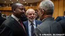 Brazilian President Luiz Inacio Lula da Silva (C) and Prime Minister of Ethiopia Abiy Ahmed (L) speak with a delegate before the opening ceremony of the 37th Ordinary Session of the Assembly of the African Union (AU) at the AU headquarters in Addis Ababa on February 17, 2024. (Photo by Amanuel Sileshi / AFP)