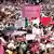 Pro-electoral authority protest in Mexico City with pink and white clothing and signs and Mexican flags