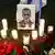 Candles and flowers near a black and white photograph of former Russian opposition figure Alexei Navalny