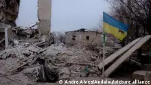 ORICHIV, UKRAINE - JANUARY 23: A view of the Ukrainian flag in front of the destroyed building by aerial bombs on the front line as the Russia-Ukraine war continues in Orichiv, Ukraine on January 23, 2024. Before the war, a city of 30,000 now only about 1,000 people still live there. Almost every building was shelled. It is approximately 15 km from the line of contact with Russian forces at Robotyne. Andre Alves / Anadolu