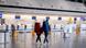 Passengers walk through a terminal at Frankfurt Airport amid the Verdi union action  