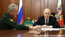 TOPSHOT - In this pool photograph distributed by Russian state agency Sputnik, Russia's President Vladimir Putin meets with Defence Minister Sergei Shoigu at the Kremlin in Moscow on February 20, 2024. (Photo by Alexander KAZAKOV / POOL / AFP)