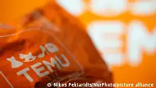 A package from Temu is seen in front of a screen with the Temu logo. (Photo by Nikos Pekiaridis/NurPhoto)