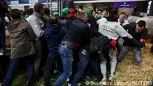 Farmers clash with members of the French police as they protest inside the Porte de Versailles exhibition centre on the day of French President Emmanuel Macron's visit to the International Agriculture Fair (Salon International de l'Agriculture) during its inauguration in Paris, France, February 24, 2024. REUTERS/Stephanie Lecocq