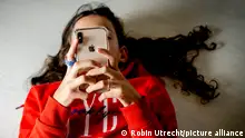 ROTTERDAM - A girl is watching tiktok on her phone. TikTok is a social media app that allows short music videos to be made and shared. The videos can have a length of 3 to a maximum of 30 seconds. Videos of 3 minutes can also be made. Robin Utrecht