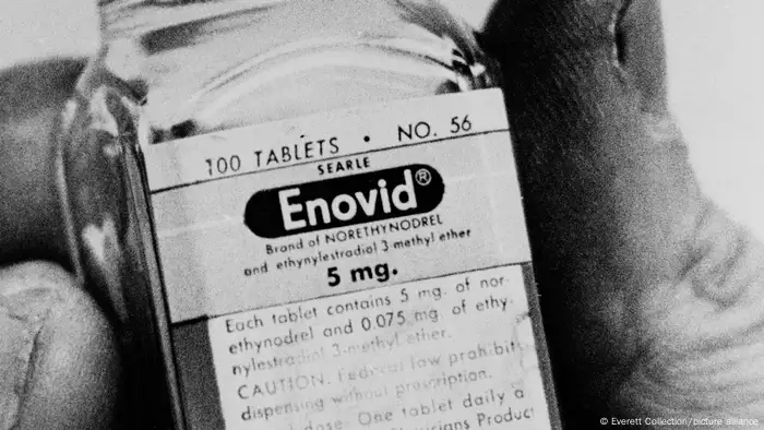 A black-and-white photo of a a bottle of Enovid pills.