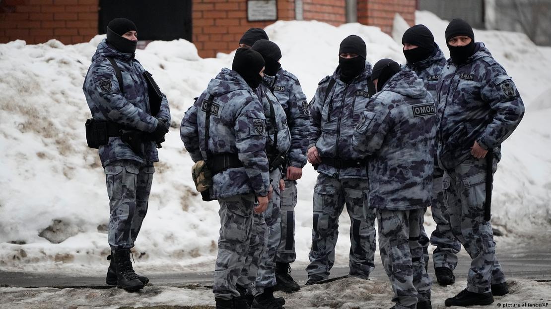 Masked riot police officers stand near the Church of the Icon of the Mother of God, in Moscow Masked riot police officers stand near the Church of the Icon of the Mother of God, in Moscow