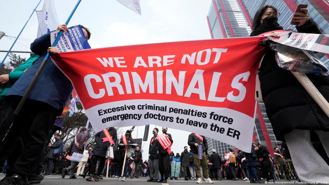 Doctors hold a banner during a rally against the government's medical policy in Seoul, South Korea, Sunday, March 3, 2024. 