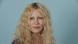 Nele Jensch stands against a plain background as she smiles into the camera. Nele Jensch stands against a plain background as she smiles into the camera.
