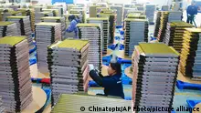 Workers labor at a factory of coolant radiators for air conditioners in Yuexi county in central China's Anhui province, on Feb. 21, 2024. Manufacturing in China contracted for a fifth consecutive month in February, according to an official survey of factory managers released Friday, March 1, 2024, reflecting persistent weakness in the economy ahead of annual legislative meetings where officials are expected to boost policy support. (Chinatopix via AP)