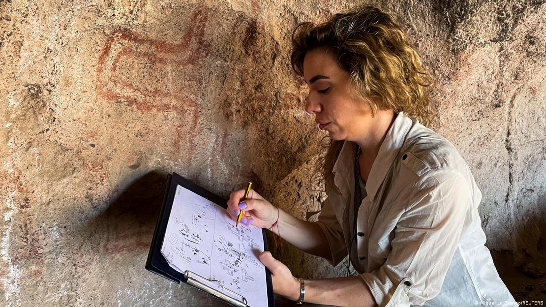 Arqueóloga argentina estudia pinturas rupestres en una cueva.