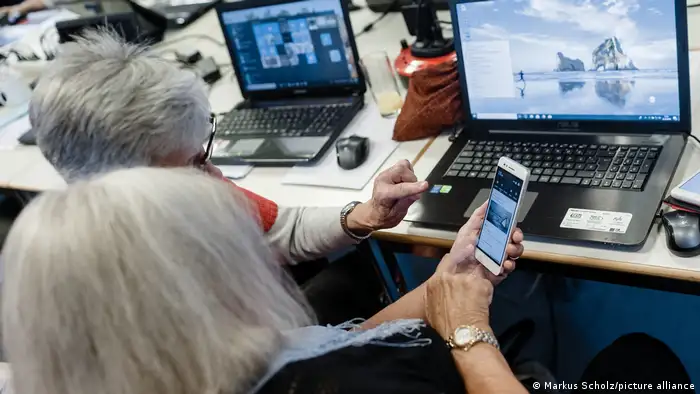 Two elderly women in a digital literacy course