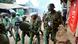 Riot police officers walk back during clashes with protesters in the Kibera area of Nairobi, Kenya Riot police officers walk back during clashes with protesters in the Kibera area of Nairobi, Kenya