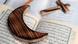 A wooden cross lies on a Bible while a wooden crescent lies on a Quran A wooden cross lies on a Bible while a wooden crescent lies on a Quran