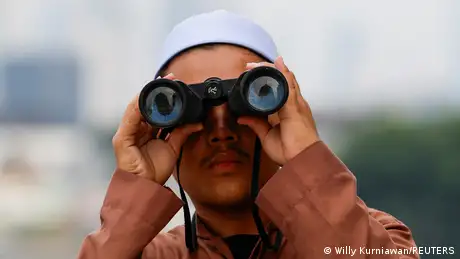A Muslim in Jakarta watches the position of the crescent moon over Indonesia from the roof of the Al-Musyari'in mosque. 