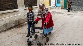 A child and an elderly woman with a rollator in Morocco
