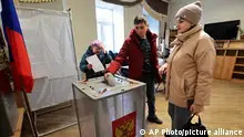 A man casts a ballot at a polling station during a presidential election in the Pacific port city of Vladivostok, 6418 kms. (3566 miles) east of Moscow, Russia, Friday, March 15, 2024. Voters in Russia are heading to the polls for a presidential election that is all but certain to extend President Vladimir Putin's rule after he clamped down on dissent. (AP Photo)