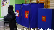 A woman seen entering a voting booth at a polling station as voting begins for the 2024 Russian presidential election. Four candidates are participating in the elections: the leader of the LDPR Slutsky, a member of the Communist Party Kharitonov, the current head of state, self-nominated Putin and a member of the New People Party Davankov. (Photo by Maksim Konstantinov / SOPA Images/Sipa USA)