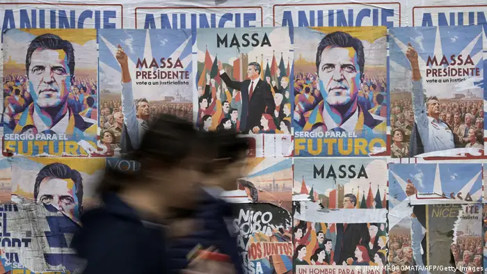 People walk past electoral propaganda of Economy Minister and presidential candidate of the Union por la Patria party, Sergio Massa, made with AI.