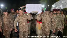 Chief of Army Staff (COAS) of Pakistan Asim Munir and General Sahir Shamshad Mirza, Chairman of the Joint Chiefs of Staff Committee (JCSC) along with others carry the coffin as they attend the funeral of Lieutenant Colonel Syed Kashif Ali, 39 and Captain Muhammad Ahmed Badar, 23, after according to military, militants attacked a military post in Mir Ali, North Waziristan district in Pakistan near Afghanistan early on Saturday using a vehicle laden with explosives as well as suicide bombs, during the funeral at Chaklala Garrison, Rawalpindi, Pakistan March 17, 2024. Inter-Services Public Relations (ISPR)/Handout via REUTERS THIS IMAGE HAS BEEN SUPPLIED BY A THIRD PARTY NO RESALES. NO ARCHIVES.
