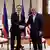 Antony Blinken (left) and Philippines' Secretary of Foreign Affairs Enrique Manalo pose while shaking hands at a hotel in Manila, March 19, 2024