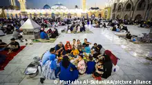 Muslims have a sunset meal in a mosque complex in Baghdad.