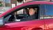 Two men in a red car Two men in a red car