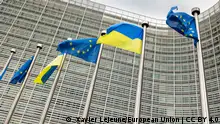 European and Ukrainian flags blowing in the wind, in front of the European Commission