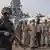 A police officer stands guard as Mumbai Police takes charge of the accused Somali pirates brought by the Indian navy on its warship INS Kolkata