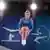  Iana Lebedeva holds her knees as she jumps from a trampoline
