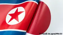 Background of the flags of the north korea and Japan. The concept of interaction or counteraction between the two countries. International relations. political negotiations. Sports competition.