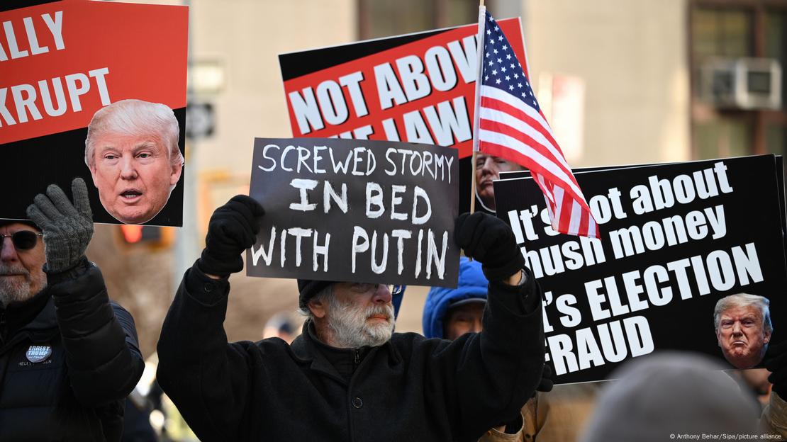 Manifestantes con pancartas sobre Trump ante la corte de Nueva York, el 25 de marzo de 2024.