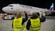 Eurowings plane with two Deutsche Post workers seen from the back as they wave Eurowings plane with two Deutsche Post workers seen from the back as they wave