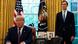 Donald Trump sitting at his desk in the Oval Office with his son-in-law Jared Kushner standing next to him Donald Trump sitting at his desk in the Oval Office with his son-in-law Jared Kushner standing next to him