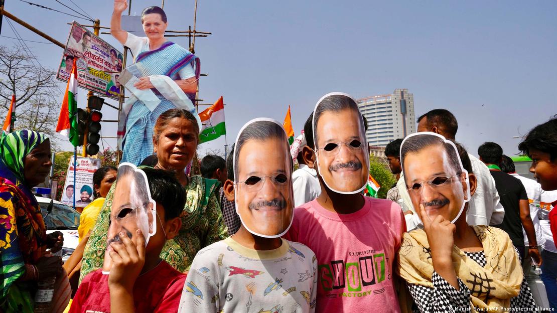 Supporters of the Aam Admi Party wear masks in the likeness of the party leader and Delhi Chief Minister Arvind Kejriwal at a protest rally organized by INDIA bloc