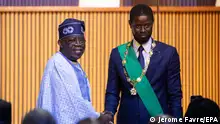 epa11255416 Newly sworn in Senegalese President Bassirou Diomaye Faye (R) is congratulated by Nigerian President Bola Ahmed Tinubu (L) during his inauguration ceremony at the Abdou Diouf International Convention Centre in Diamniadio, Senegal, 02 April 2024. Faye, freed from jail on 14 March, won the election on the first round claiming 54,28 percent of the votes. EPA/JEROME FAVRE