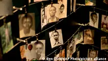 Family photographs of some of those who died hang in a display in the Kigali Genocide Memorial Centre in Kigali, Rwanda Saturday, April 5, 2014. The country will commemorate on April 7, 2014 the 20th anniversary of the genocide when ethnic Hutu extremists killed neighbors, friends and family during a three-month rampage of violence aimed at ethnic Tutsis and some moderate Hutus, leaving a death toll that Rwanda puts at 1,000,050. (AP Photo/Ben Curtis)
