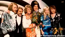FILE - In this April 6, 1974 file photo, members of Swedish group ABBA and close associates celebrate the victory of their song Waterloo in the Eurovision Song Contest in Brighton, England. The Eurovision Song Contest has always been a sign of its times. Despite the cancellation of the wildly popular contest in Europe and beyond, the evening the finale on Saturday, May 16, 2020 will bring some respite for diehards, with a remote television show beamed to over 40 nations. (AP Photo,File)