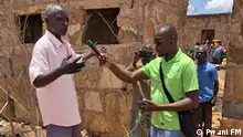 A Pwani FM reporter speaks to someone on location